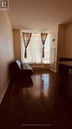 Toronto (University) condo for rent - A living room with a brown couch and a window with curtains.