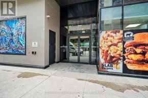 Toronto (Church-Yonge Corridor) condo for rent - A building entrance with a sign for RE/MAX Hallmark Realty.