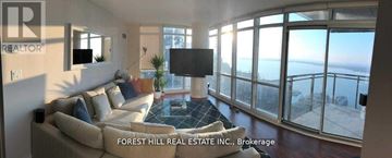 Toronto (Waterfront Communities) condo for rent - A living room with a couch and a television with a view of the ocean.