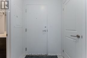 Toronto (Moss Park) condo for rent - A white door with a handle and a small square on the wall.