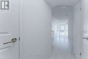 Toronto (Moss Park) condo for rent - A white hallway with doors on either side and a logo in the top left corner.