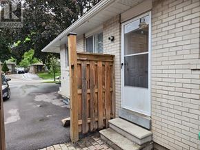 Mississauga (Clarkson) apartment for rent - A house with a wooden gate in front of it.