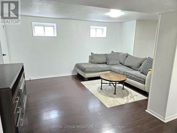 Mississauga (Clarkson) apartment for rent - A living room with a grey couch and a wooden coffee table.
