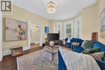 Hamilton apartment for rent - A living room with a blue couch and a glass coffee table.