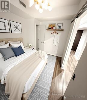 Toronto (Church-Yonge Corridor) condo for rent - A bedroom with a bed, pillows, a blanket, a coat hanger, and a mirror.
