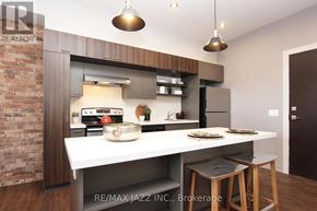 Oshawa (O'neill) multi-family for rent - A modern kitchen with a brick wall and a white countertop.