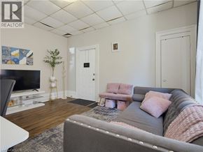 London apartment for rent - A living room with a grey couch and a television.