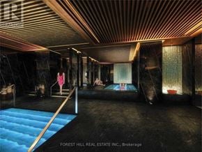 Toronto (Mount Pleasant West) condo for rent - A woman in a pink dress is standing in a room with a blue pool.