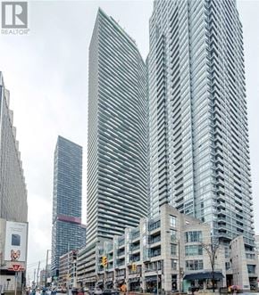 Toronto (Mount Pleasant West) condo for rent - A city street with a large building in the background.