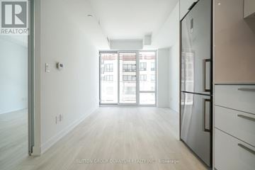 Toronto (Church-Yonge Corridor) condo for rent - A kitchen with a refrigerator and a view of a building outside.