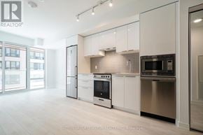 Toronto (Church-Yonge Corridor) condo for rent - A modern kitchen with white cabinets and stainless steel appliances.