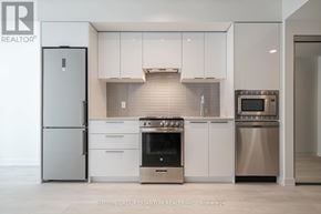 Toronto (Church-Yonge Corridor) condo for rent - A modern kitchen with stainless steel appliances and white cabinets.