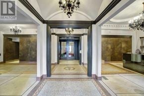 Toronto (Church-Yonge Corridor) condo for rent - A hallway with a chandelier and a carpeted floor.