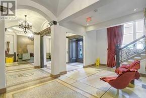 Toronto (Church-Yonge Corridor) condo for rent - A spacious hallway with a red chair and a chandelier.