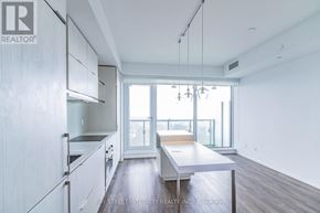 Toronto (Church-Yonge Corridor) condo for rent - A spacious kitchen with white cabinets and a large island.