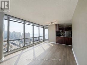 Toronto (Waterfront Communities) condo for rent - A spacious room with a view of the cityscape through large windows.