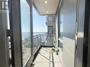 Toronto (Waterfront Communities) condo for rent - A balcony with a glass railing and a view of the city.