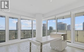 Toronto (Church-Yonge Corridor) condo for rent - A spacious room with a view of the cityscape through large windows.