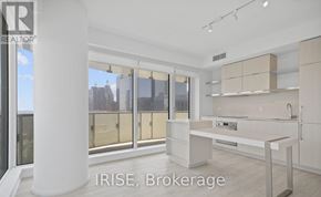 Toronto (Church-Yonge Corridor) condo for rent - A modern kitchen with white cabinets and a large island.