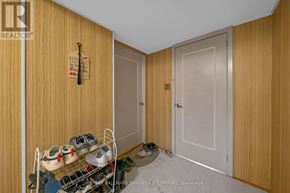 Toronto (Willowdale West) apartment for rent - A brokerage sign is on the door of a room with a shoe rack and a pair of shoes.