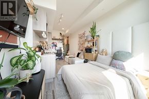 Toronto (Humewood-Cedarvale) condo for rent - A well-lit bedroom with a large bed and a desk with a chair.