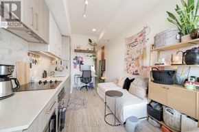 Toronto (Humewood-Cedarvale) condo for rent - A kitchen with a dining area and a bed in the living room.