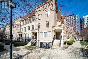 Toronto (Niagara) townhouse for rent - A beige building with a black railing in front.