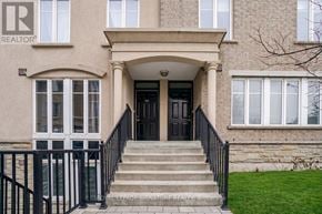 Toronto (Niagara) townhouse for rent - A beige building with a black door and a sign that says REALTOR.
