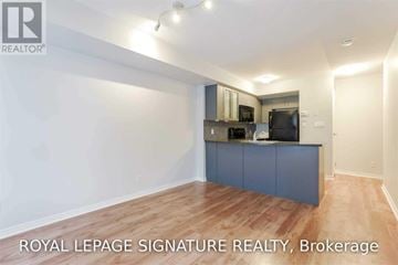 Toronto (Niagara) townhouse for rent - A spacious kitchen with a blue cabinet and wooden flooring.