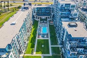 Grimsby (Grimsby Beach) condo for rent - An aerial view of a modern apartment complex with a pool in the center.