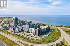 Grimsby (Grimsby Beach) condo for rent - A real estate company logo is displayed on a building in a coastal city.