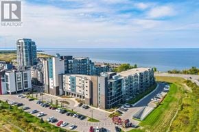 Grimsby (Grimsby Beach) condo for rent - A real estate company logo is displayed on a building in a coastal city.