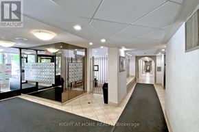 Toronto (Tam O'shanter-Sullivan) condo for rent - A hallway with a black carpet and white walls.