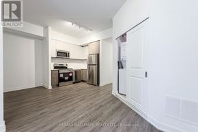 Toronto (Oakridge) townhouse for rent - A kitchen area with a refrigerator, microwave, and oven.