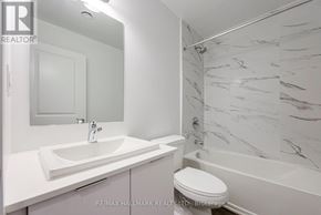 Toronto (Oakridge) townhouse for rent - A white bathroom with a marble shower wall.