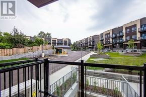Toronto (Oakridge) townhouse for rent - A view of a residential area with apartment buildings and a road.