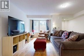 Clarington (Bowmanville) townhouse for rent - A living room with a flat screen TV on a wooden stand.