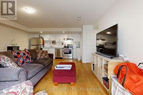 Clarington (Bowmanville) townhouse for rent - A living room with a grey couch and a red ottoman.