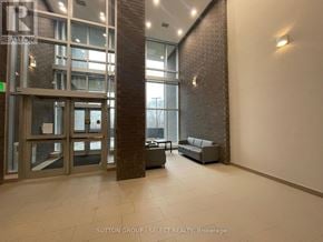 London South (South J) condo for rent - A hallway with a glass door and a brick pillar.