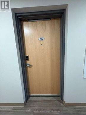 London South (South J) condo for rent - A wooden door with the number 202 on it.