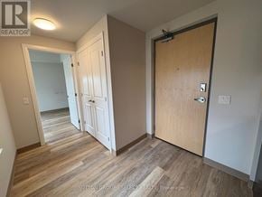 London South (South J) condo for rent - A hallway with a white door and a brown door.