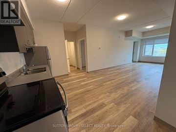 London South (South J) condo for rent - A kitchen area with a stove top oven and a sink.