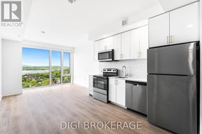 Ottawa condo for rent - A modern kitchen with a refrigerator, microwave, and oven.