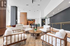 Ottawa condo for rent - A modern living room with white furniture and a wooden coffee table.
