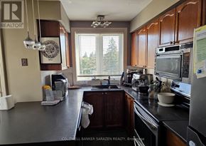 Ottawa townhouse for rent - A kitchen with a large island and a microwave on top.