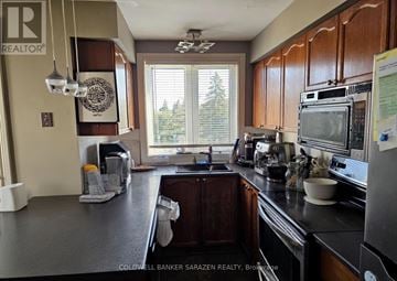 Ottawa townhouse for rent - A kitchen with a large island and a microwave on top.