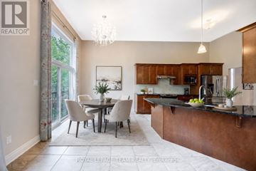 Ottawa apartment for rent - A well-lit kitchen with a dining table and chairs.
