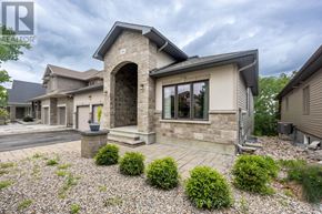 Ottawa apartment for rent - A house with a stone archway entrance and a gravel driveway.