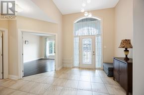 Ottawa apartment for rent - A spacious room with a large window and a lamp on a side table.