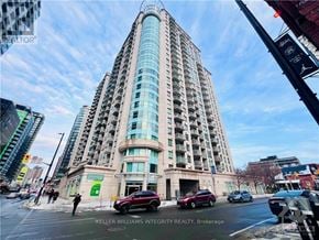 Ottawa condo for rent - A tall building with a glass facade is the focal point of the image.